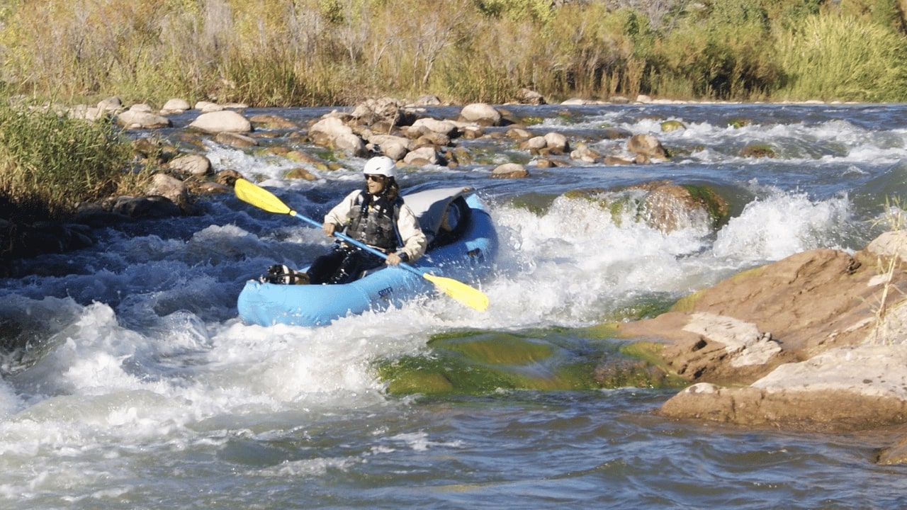 Rapid waves on the Verde River with kayaker riding the river.