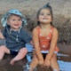 two kids sitting in the Verde river