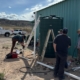 people working on installing a rainwater collection tank