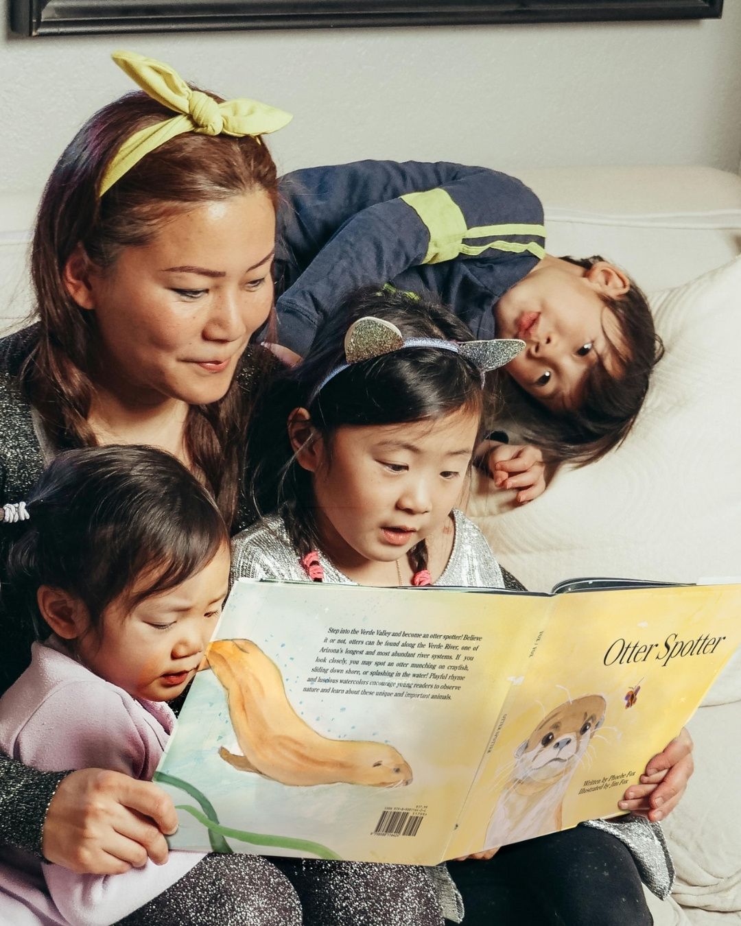 Otter Spotter family reading book (3) Mother reads the book "Otter Spotter" to her three children
